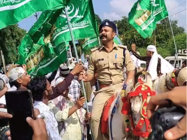 You are currently viewing ईद मिलाद उन नबी जुलूस में घोड़े पर बैठे पुलिस अधिकारी हाथ में धार्मिक झंडा लिए नजर आए, SP ने मांगा जवाब; एसडीओपी बोले— “सिर्फ सुरक्षा का निरीक्षण कर रहा था, झंडा किसी ने पकड़ा दिया”!